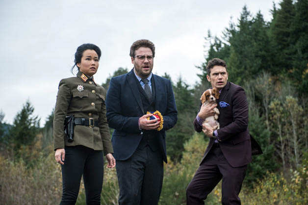 James Franco clutches puppy alongside Seth Rogen in a still from The Interview