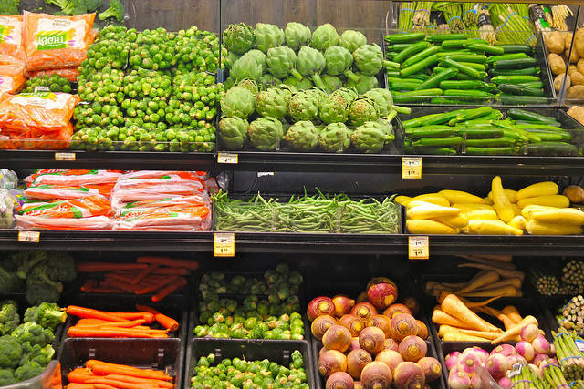 Fruit and vegetables on display on the shelves of a supermarket