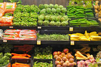 Fruit and vegetables on display on the shelves of a supermarket