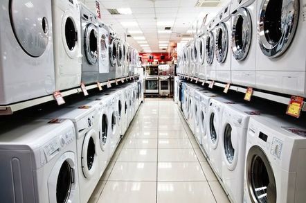 Rows of washing machines in shop aisle