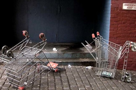Two upended shopping trolleys in an alleyway. Photo by Cyron, licensecd under CC 2.0