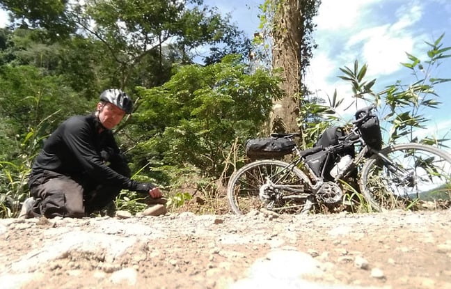 Gavin and his bike on a jungle trail