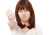 Woman thumbs down, image via Shutterstock