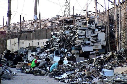 "Typical E-scrapping dismantling operation. 100,000 such migrant workers labor in Guiyu breaking down imported computers in hundreds of small operations like this one in a four village area surrounding the Lianjiang River."