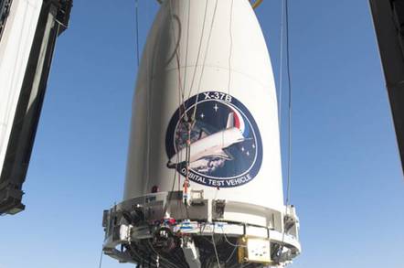 The X-37B space plane being hoisted into position