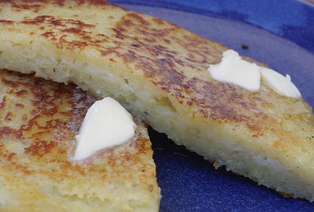 A view of sliced boxty with melted butter