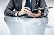 Business suited man with clipboard