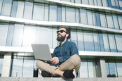 Hipster with laptop photo via Shutterstock