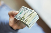Handing over dollars picture via Shutterstock