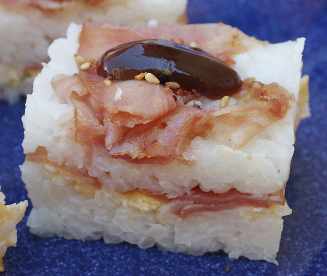Close-up of a finished portion of bacon and egg oshizushi 