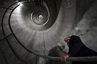 Man looking up spiral staircase inside deltalis mountain data centre