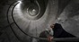 Man looking up spiral staircase inside deltalis mountain data centre