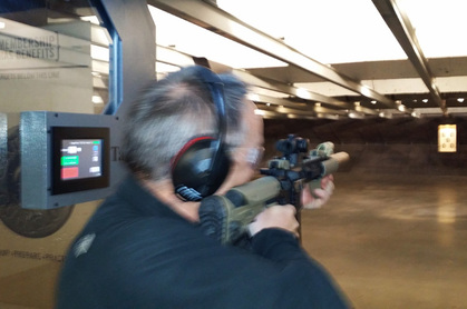 Lester firing an AR-15 assault rifle