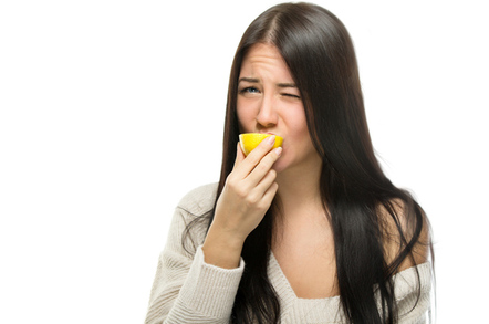 Biting lemon image via Shutterstock