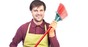 Househusband: Man in apron wields broom. Image via Shutterstock