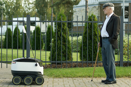 A Starship bot face-tp-face with a pensioner on the street