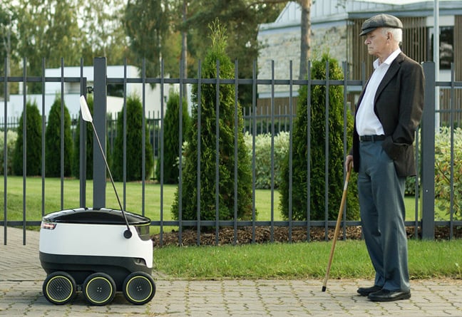 A Starship bot face-tp-face with a pensioner on the street