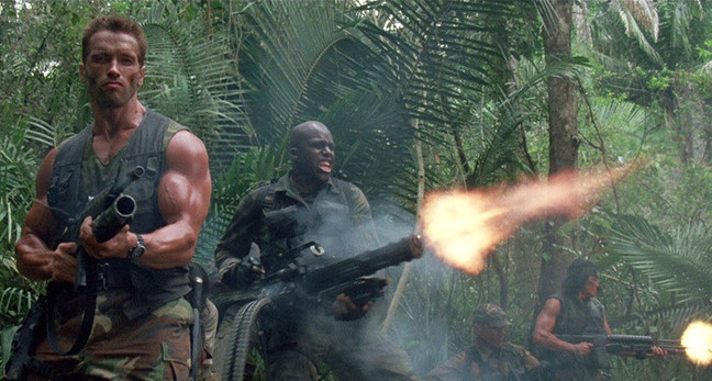 Still from Predator showing Arnie holding the M-16