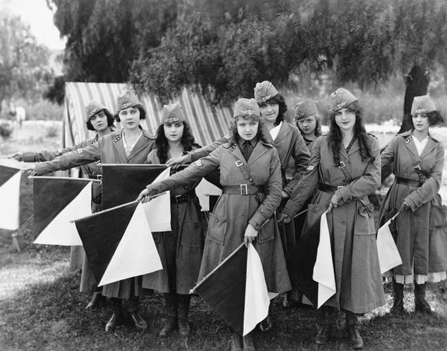 Female signal corps with semaphore flags. Photo from Everett Collection via Shutterstock