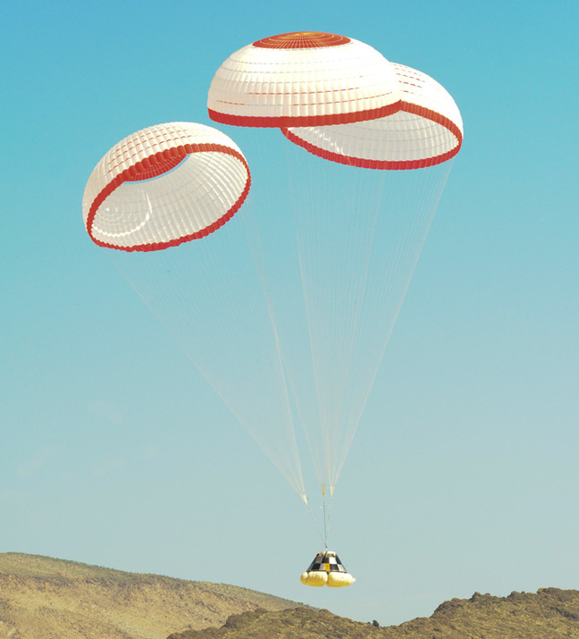 The Starliner floats to earth under three 'chutes during testing back in 2012