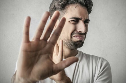 Disgusted man holds his hand up to obscure his view. Pic via Shutterstock
