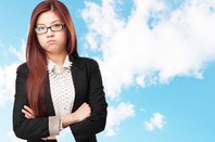 Angry-looking woman croses her arms and glares. Pic by Shutterstock