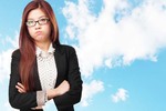 Angry-looking woman croses her arms and glares. Pic by Shutterstock