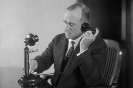 man_on_old_phone_image_via_shutterstock.