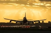 Boeing 747 lands at dusk. Photo via Shutterstock