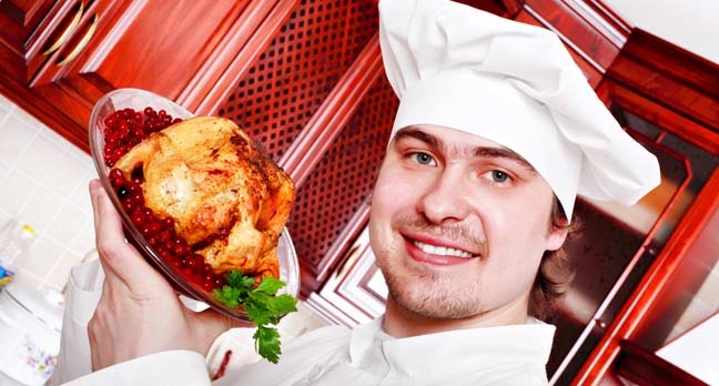 chef presents a roast chicken in pomegranate sauce. Photo by Shutterstock