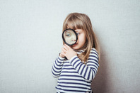 Girl magnifying glass, photo via Shutterstock