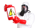 person in chemical repelling suit with a suspicious bottle