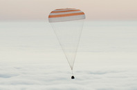 The Soyuz capsule descending under its parachute this morning. Pic: NASA/Bill Ingalls
