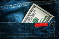 Dollar in pocket, photo via Shutterstock