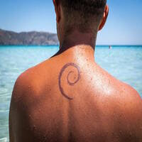 man with debian logo tattoo