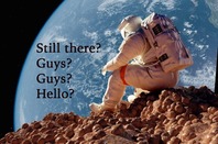 An astronaut sits alone on a rocky surface of another planet. Photo by SHutterstock