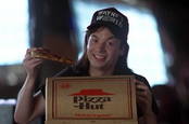 Wayne's World product placement visual gag (Wayne eats Pizza Hut pizza, displays branding, while talking about product placement)