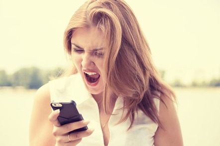 Woman angrily hangs up phone. Photo via Shutterstock