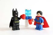 Studio shot of LEGO minifigure Batman and Superman standing by a water cooler with drinks. Copyright: cjmacer Editorial Credit: cjmacer / Shutterstock.com Editorial Use Only. 