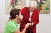 A grandmother gives cash to grandson. Photo by Shutterstock