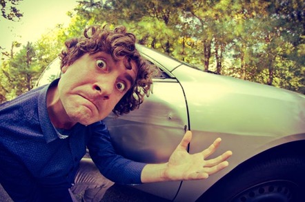 Man gesticulates furiously in front of parked car. Photo by Shutterstock