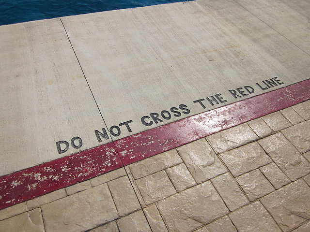 do not cross the red line notice painted at side of swimming pool