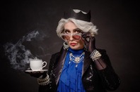 Funny pic of "British" woman in tiara posing with cup of tea, crown and ... jewels. Photo by Shutterstock