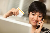 Woman pays for something online with her credit card. Photo by Shutterstock