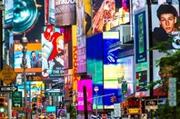 Collage of neon lights, street signs and advertisements at Times Square in New York City on June 23, 2013. Times Square holds the annual New Year's Eve ball drop. Photo by Allen G/Shutterstock for editorial use only