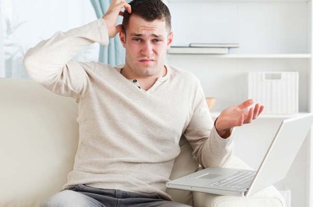 Confused/annoyed looking man looks irritated during outage. Photo via Shutterstock
