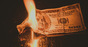 Burning money, photo via Shutterstock