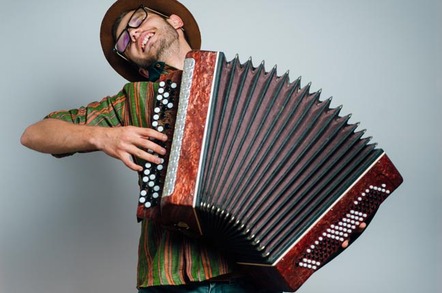 Hipster guy plays accordion. Photo by Shutterstock