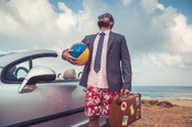 Guy in shirt and tie visits the beach. wearing "beach business-casual". Photo by Shutterstock