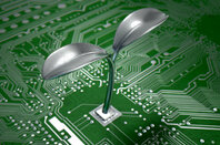 Metal plant grows out of circuit board - Green IT concept pic. Photo by Shutterstock